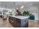 Open-concept view of kitchen island, dining area, and staircase in a bright and modern home at 12193 W 51St Ave, Wheat Ridge, CO 80033