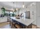Spacious kitchen featuring white cabinets, stainless steel appliances, and large center island with seating at 12193 W 51St Ave, Wheat Ridge, CO 80033