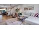 Open-concept living area with comfortable seating, hardwood floors, and a dining area, perfect for modern living at 12193 W 51St Ave, Wheat Ridge, CO 80033