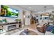 Bright living room with fireplace, TV, hardwood floors, and staircase to the upper floor at 12193 W 51St Ave, Wheat Ridge, CO 80033