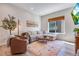 Bright living room featuring a comfortable sectional sofa, modern décor, and a large window for natural light at 12193 W 51St Ave, Wheat Ridge, CO 80033