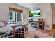 Inviting living room with modern decor, featuring a sectional sofa, entertainment center, and a large window at 12193 W 51St Ave, Wheat Ridge, CO 80033