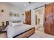 Cozy main bedroom with a modern rustic design, featuring a barn door leading to the ensuite bathroom at 12193 W 51St Ave, Wheat Ridge, CO 80033