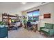 Well-lit home office with dual desks, ample storage, and a large window overlooking the neighborhood at 12193 W 51St Ave, Wheat Ridge, CO 80033