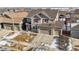 Two-story house aerial view, two-car garage, snowy yard at 9170 Fig St, Arvada, CO 80005