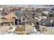 Two-story house aerial view, two-car garage, snowy yard at 9170 Fig St, Arvada, CO 80005