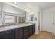 Elegant bathroom with double sinks, granite counters, and a large shower at 9170 Fig St, Arvada, CO 80005