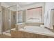 Spa-like bathroom featuring a soaking tub and a walk-in shower at 9170 Fig St, Arvada, CO 80005