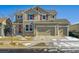 Two-story house with three car garage, red shutters, and landscaping at 9170 Fig St, Arvada, CO 80005