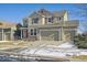 Two-story house, beige exterior, red accents at 9170 Fig St, Arvada, CO 80005