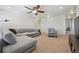 Spacious living room with a comfortable sectional sofa and ceiling fan at 9170 Fig St, Arvada, CO 80005