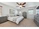 Main bedroom with ceiling fan, carpeted floors and ensuite bathroom at 9170 Fig St, Arvada, CO 80005