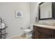 Small powder room with vanity and toilet at 9170 Fig St, Arvada, CO 80005