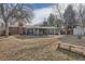 Large backyard with patio area, grassy area and mature trees at 7005 S Ash Cir, Centennial, CO 80122