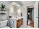 Bright bathroom featuring a wooden vanity, tiled floors, and sleek fixtures at 7005 S Ash Cir, Centennial, CO 80122
