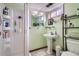 Cozy bathroom features a pedestal sink and walk-in shower with shelving for toiletries at 7005 S Ash Cir, Centennial, CO 80122