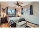 Bright bedroom with hardwood floors, a ceiling fan, and natural light from the windows at 7005 S Ash Cir, Centennial, CO 80122