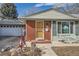 Charming home featuring brick accents, a well-manicured lawn, and an attached garage at 7005 S Ash Cir, Centennial, CO 80122
