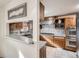 Traditional kitchen featuring wooden cabinetry, stainless steel appliances, and tile backsplash at 7005 S Ash Cir, Centennial, CO 80122