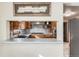 Eat-in kitchen featuring modern appliances, tile backsplash, and ample counter space at 7005 S Ash Cir, Centennial, CO 80122