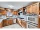 Kitchen with stainless steel appliances, tile flooring, and bright lighting at 7005 S Ash Cir, Centennial, CO 80122