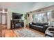 Comfortable living room with a fireplace, hardwood floors, and large windows at 7005 S Ash Cir, Centennial, CO 80122