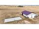 Aerial view of a property with a large outbuilding and basketball court in a rural setting at 26100 County Road 5, Elizabeth, CO 80107