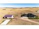 Aerial view of a house, detached garage, and expansive land at 26100 County Road 5, Elizabeth, CO 80107