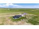 Captivating aerial view displays the home, surrounding greenery, and outbuilding on a stunning lot with expansive views at 26100 County Road 5, Elizabeth, CO 80107