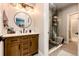 Stylish bathroom with a wood vanity, elegant mirror, and modern glass-enclosed shower at 26100 County Road 5, Elizabeth, CO 80107