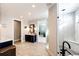Bright bathroom with a glass-enclosed shower, double vanity with blue cabinets, and tile flooring at 26100 County Road 5, Elizabeth, CO 80107