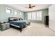 Serene bedroom with a large window, plantation shutters, a ceiling fan, and neutral carpeting at 26100 County Road 5, Elizabeth, CO 80107