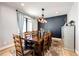 Formal dining room with hardwood floors, large table, and modern light fixture at 26100 County Road 5, Elizabeth, CO 80107