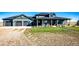 Modern farmhouse exterior with a three-car garage and covered porch at 26100 County Road 5, Elizabeth, CO 80107