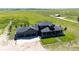 Aerial view of home showing three car garage, covered porch and landscaping at 26100 County Road 5, Elizabeth, CO 80107