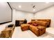 Cozy home theater room featuring a large screen, projector, and comfortable, plush seating at 26100 County Road 5, Elizabeth, CO 80107