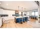 Modern kitchen with white cabinets, a large island, and blue accents at 26100 County Road 5, Elizabeth, CO 80107