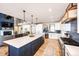 Modern kitchen with white cabinets, a large island, and blue accents at 26100 County Road 5, Elizabeth, CO 80107