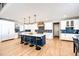 Gourmet kitchen boasts a large center island with seating, custom cabinetry, and stainless steel appliances at 26100 County Road 5, Elizabeth, CO 80107
