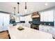 Modern kitchen with white cabinets, a large island, and blue accents at 26100 County Road 5, Elizabeth, CO 80107