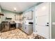 Functional laundry room with gray cabinets, patterned tile floor, and stainless steel washer and dryer at 26100 County Road 5, Elizabeth, CO 80107