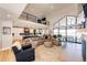 Spacious living room with fireplace, high ceilings, and access to the outdoors at 26100 County Road 5, Elizabeth, CO 80107