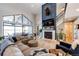 Large open living room with fireplace, large windows, and access to upstairs loft at 26100 County Road 5, Elizabeth, CO 80107