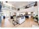 Open-concept living room and kitchen featuring hardwood floors and modern finishes throughout the expansive space at 26100 County Road 5, Elizabeth, CO 80107