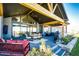 Inviting outdoor patio with comfortable seating, a dining area, and lush landscaping at 26100 County Road 5, Elizabeth, CO 80107
