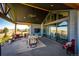 Spacious covered patio featuring comfortable seating and views of the surrounding landscape at 26100 County Road 5, Elizabeth, CO 80107