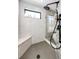 Modern shower featuring sleek black fixtures, marble-look walls, and a built-in bench at 26100 County Road 5, Elizabeth, CO 80107