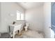 Functional utility sink and toilet in a bright, clean room offer practicality and convenience for various household tasks at 26100 County Road 5, Elizabeth, CO 80107