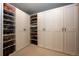 Organized walk-in closet with built-in shelving for shoes, hats, and other accessories at 26100 County Road 5, Elizabeth, CO 80107