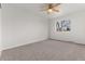 Minimalist bedroom with neutral carpet and a window overlooking the outdoors and ceiling fan at 7700 W Glasgow Pl # C, Littleton, CO 80128